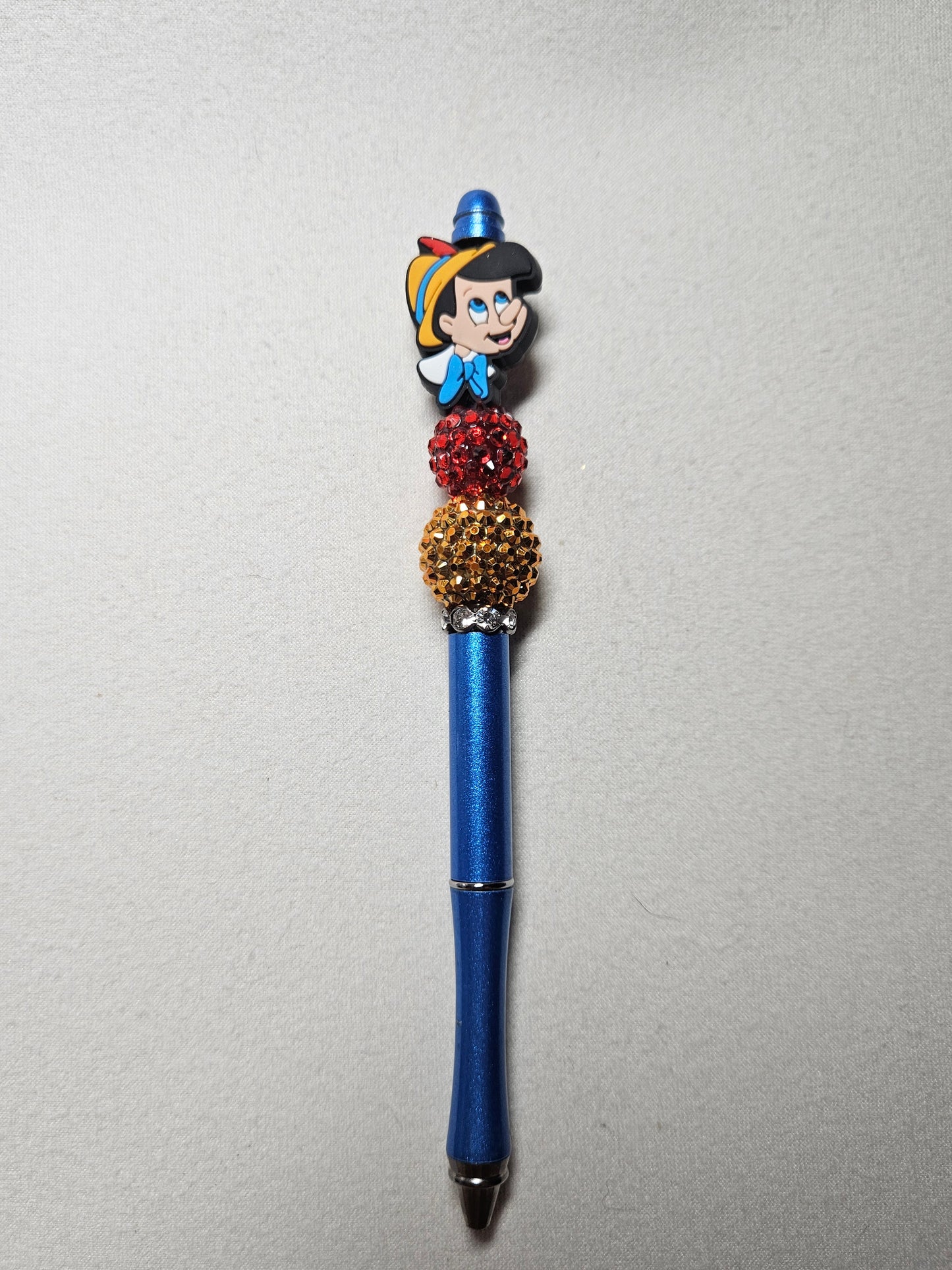 Beaded blue metal Pinocchio pen